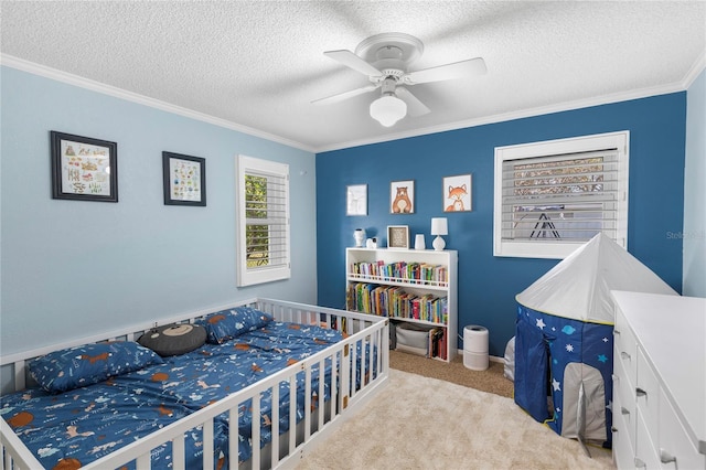 bedroom featuring carpet floors, a textured ceiling, ceiling fan, and crown molding