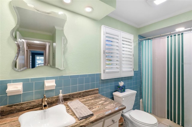 bathroom with tile walls, crown molding, toilet, a shower with shower curtain, and vanity