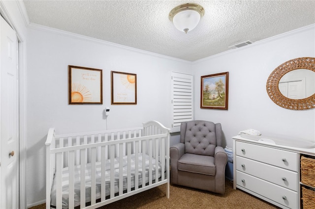 bedroom featuring visible vents, a closet, a textured ceiling, crown molding, and carpet flooring