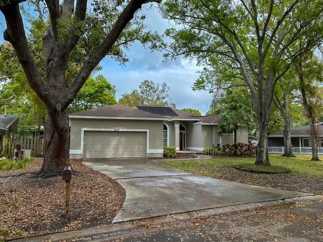 single story home featuring concrete driveway, an attached garage, fence, and stucco siding