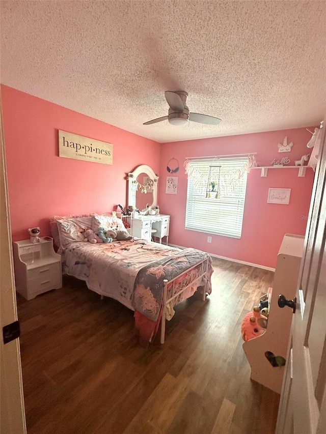 bedroom with a textured ceiling, wood finished floors, and a ceiling fan