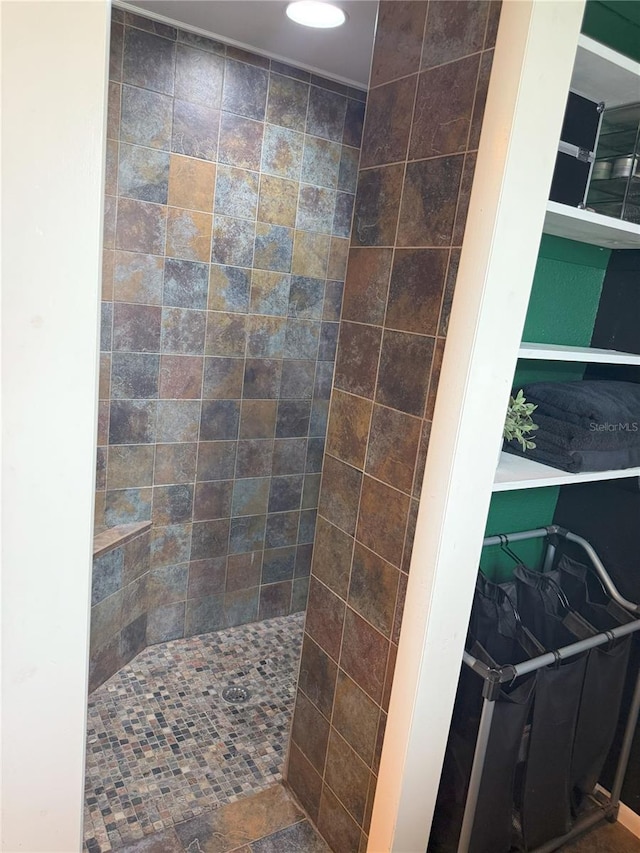 bathroom with a tile shower and recessed lighting