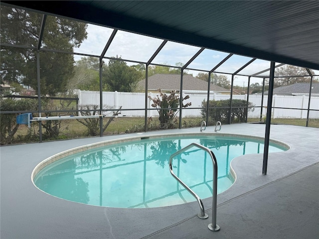 view of pool with a fenced in pool, a fenced backyard, glass enclosure, and a patio area