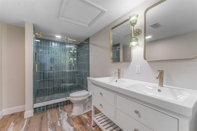 bathroom featuring visible vents, toilet, wood finished floors, and a sink