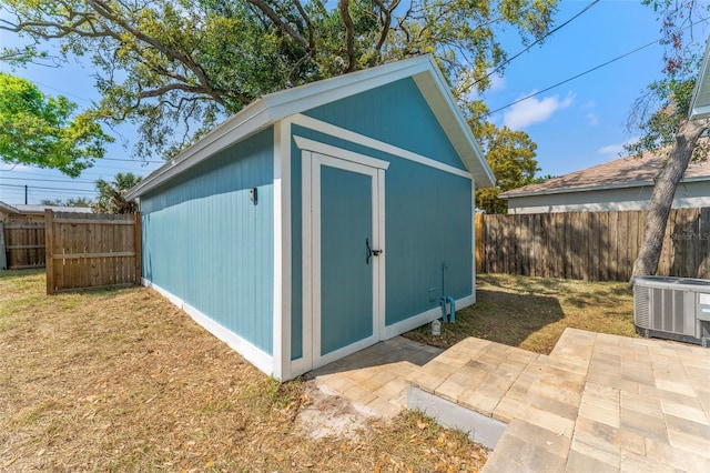 view of shed with central air condition unit and a fenced backyard