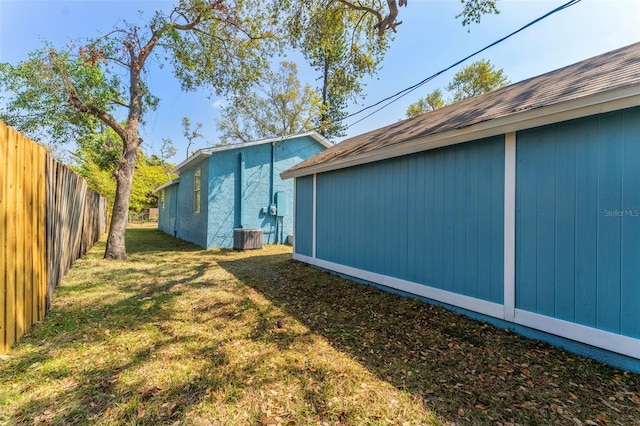 view of yard featuring cooling unit and fence