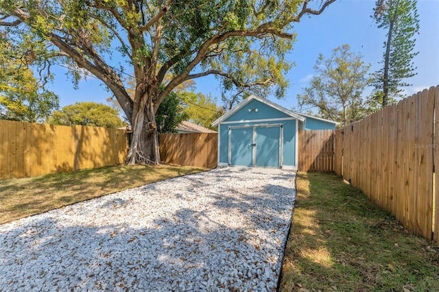 exterior space with a storage shed and fence