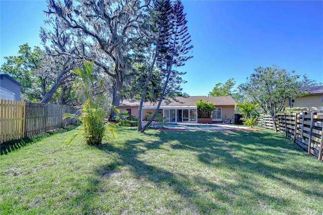 view of yard featuring a patio and a fenced backyard