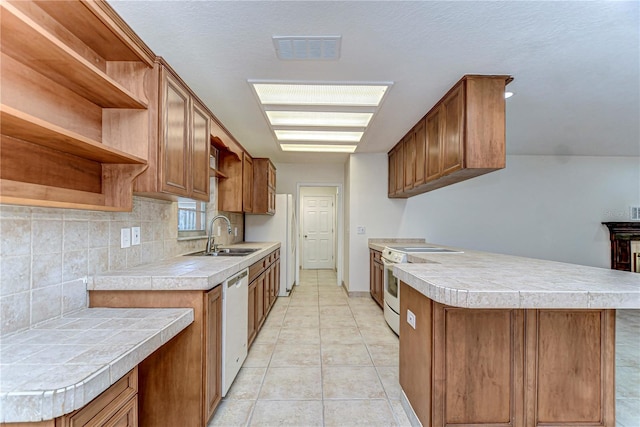 kitchen featuring white appliances, visible vents, open shelves, a sink, and tasteful backsplash