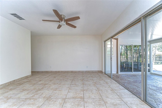 empty room featuring visible vents, baseboards, light tile patterned flooring, and a ceiling fan