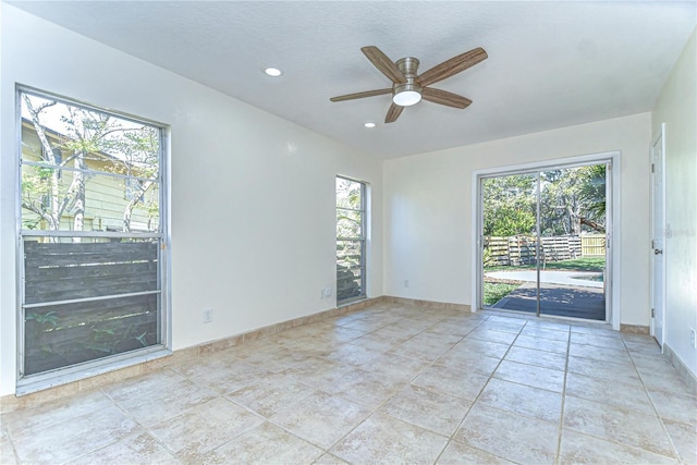 empty room featuring light tile patterned floors, recessed lighting, a ceiling fan, and baseboards