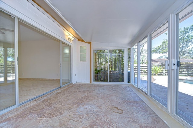 unfurnished sunroom featuring lofted ceiling