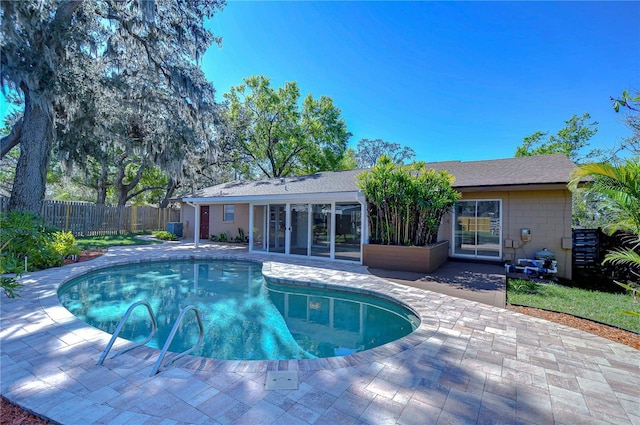 view of swimming pool with a patio area, a fenced in pool, french doors, and a fenced backyard