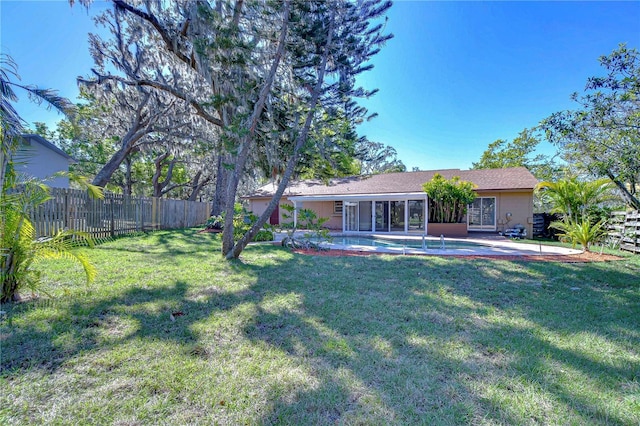 view of yard with a patio area, fence, a fenced in pool, and a sunroom