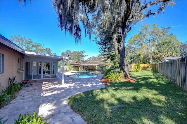 view of yard with a fenced in pool, a fenced backyard, and a patio area