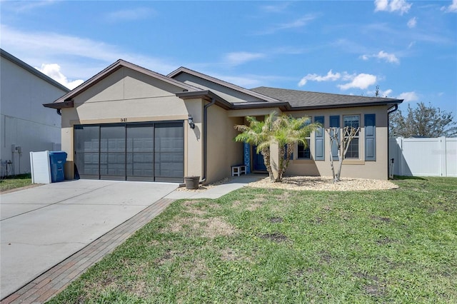 ranch-style home with concrete driveway, a front lawn, a garage, and stucco siding