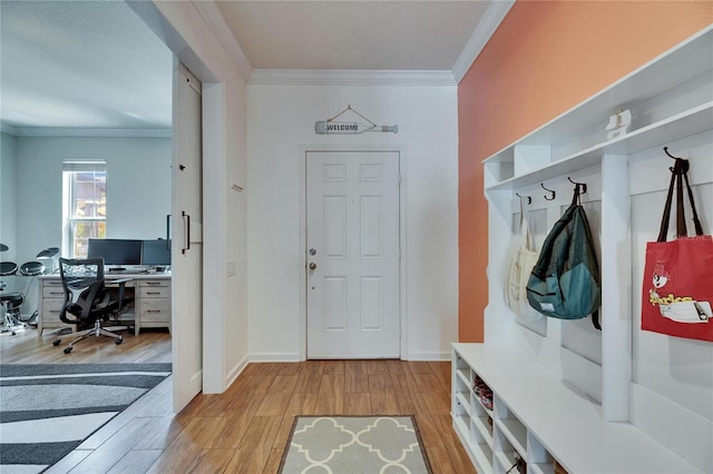 mudroom featuring baseboards, light wood-style floors, and ornamental molding