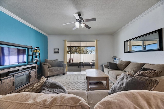 living area featuring a textured ceiling, a ceiling fan, and ornamental molding