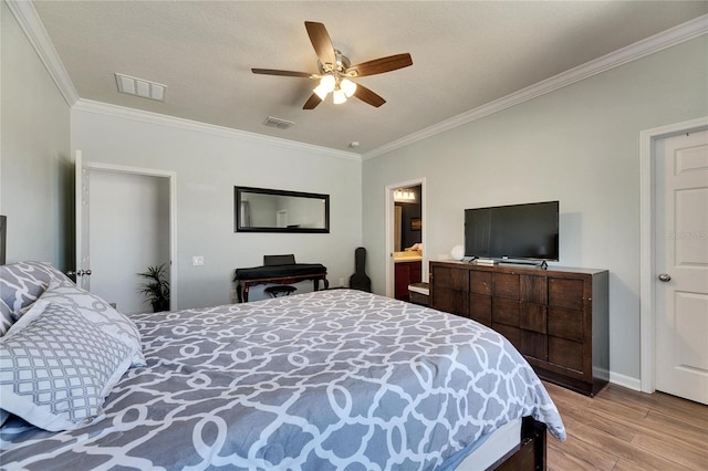 bedroom featuring ceiling fan, light wood-style floors, visible vents, and ornamental molding