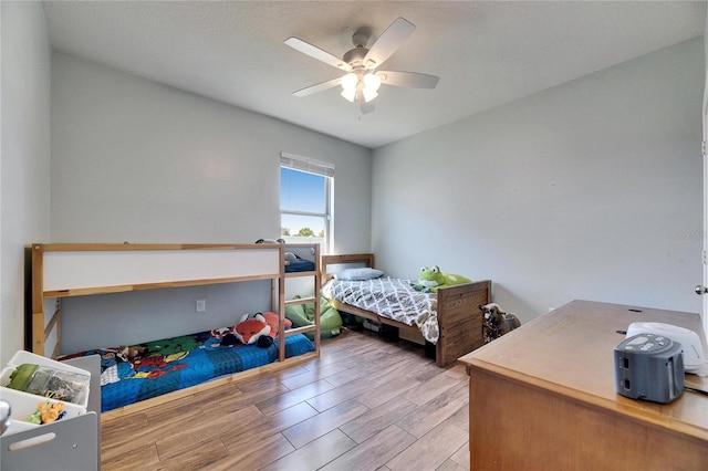 bedroom featuring a ceiling fan and wood finished floors