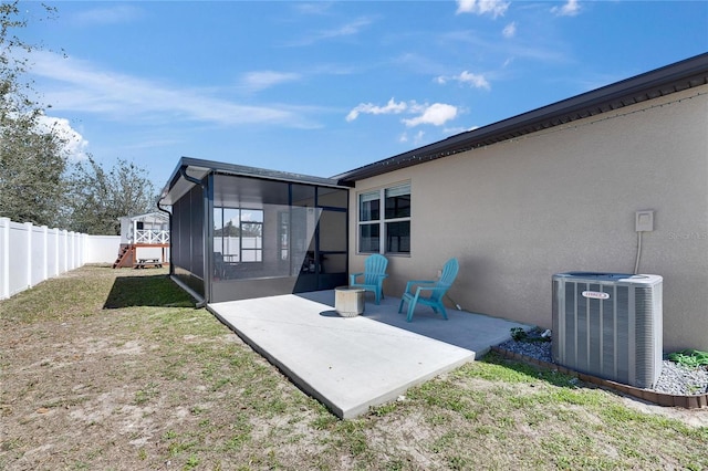 exterior space with a patio, cooling unit, a fenced backyard, and a sunroom