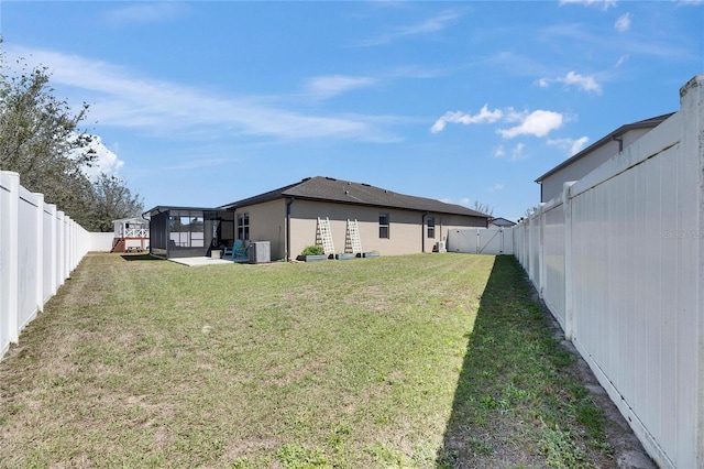 view of yard featuring a fenced backyard and a sunroom