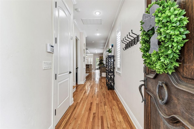 corridor featuring recessed lighting, light wood-style flooring, and baseboards