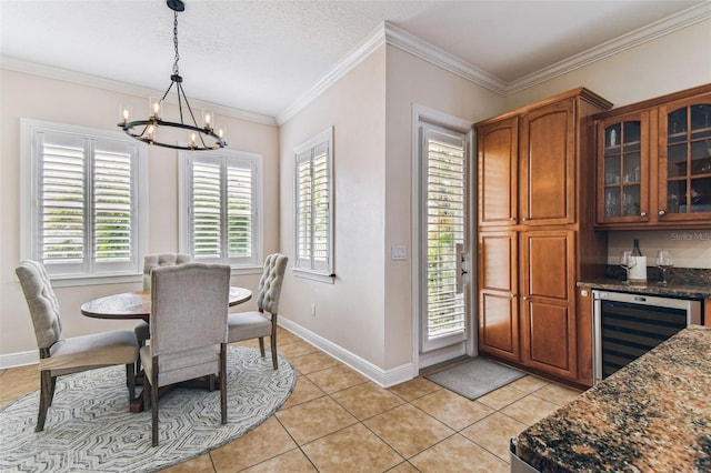 dining room featuring ornamental molding, light tile patterned floors, beverage cooler, and a chandelier