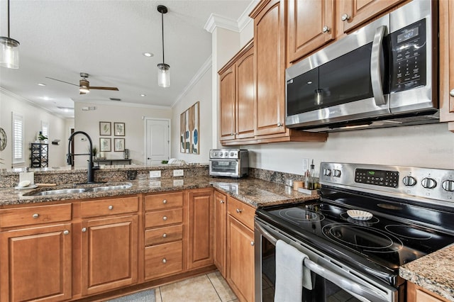 kitchen with brown cabinetry, stainless steel appliances, crown molding, and a sink