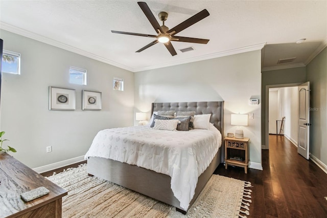 bedroom featuring visible vents, baseboards, and wood finished floors