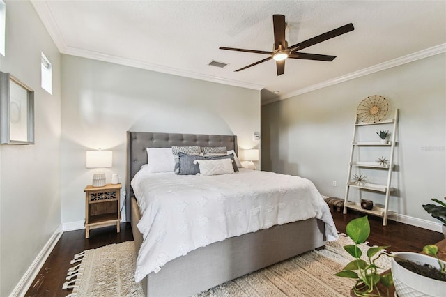 bedroom with visible vents, wood finished floors, crown molding, baseboards, and ceiling fan