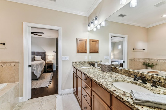 ensuite bathroom featuring a sink, visible vents, ensuite bath, and ornamental molding