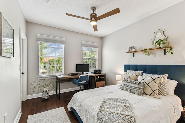 bedroom featuring a textured ceiling, a ceiling fan, baseboards, and wood finished floors