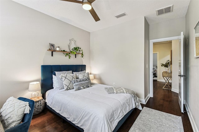 bedroom featuring visible vents, baseboards, wood finished floors, and a ceiling fan