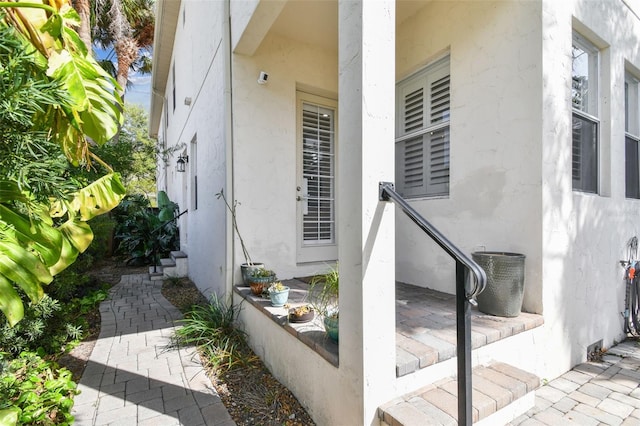 entrance to property with stucco siding