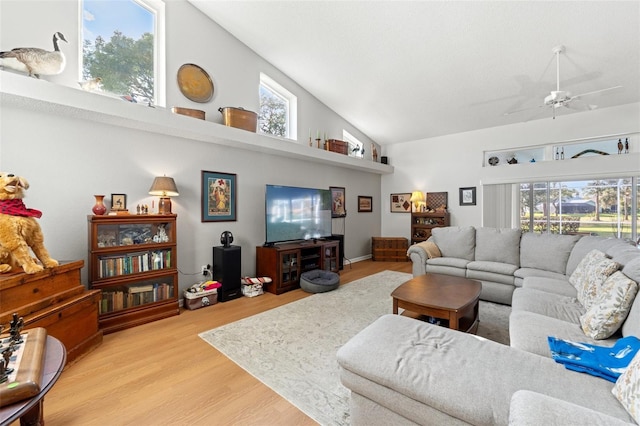 living room featuring ceiling fan, high vaulted ceiling, and wood finished floors