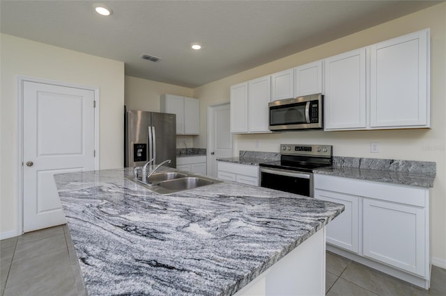 kitchen with a sink, stainless steel appliances, visible vents, and light tile patterned floors