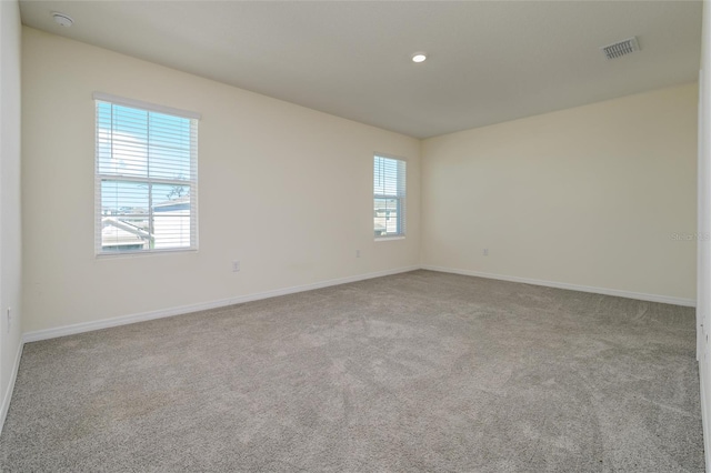 empty room with recessed lighting, visible vents, baseboards, and carpet flooring