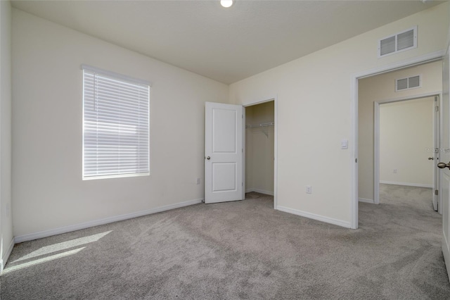 unfurnished bedroom featuring carpet flooring, baseboards, visible vents, and a closet