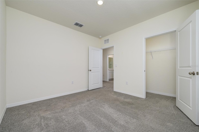 unfurnished bedroom featuring visible vents, baseboards, a closet, and carpet flooring