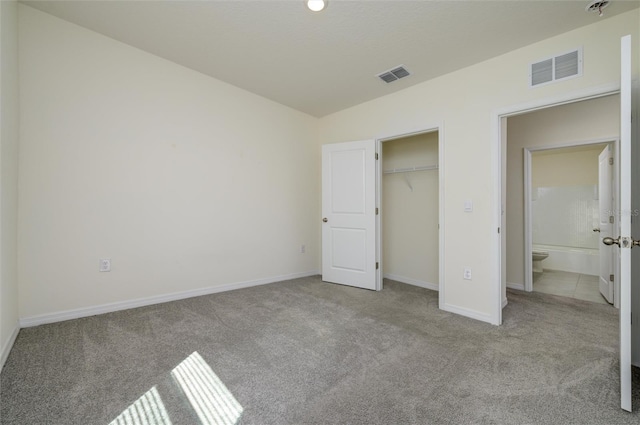 unfurnished bedroom with a closet, visible vents, baseboards, and carpet