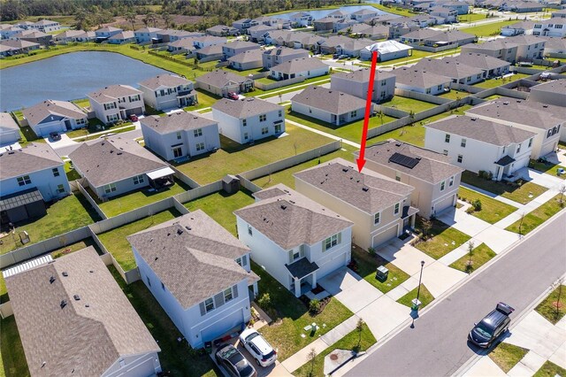 drone / aerial view featuring a residential view and a water view