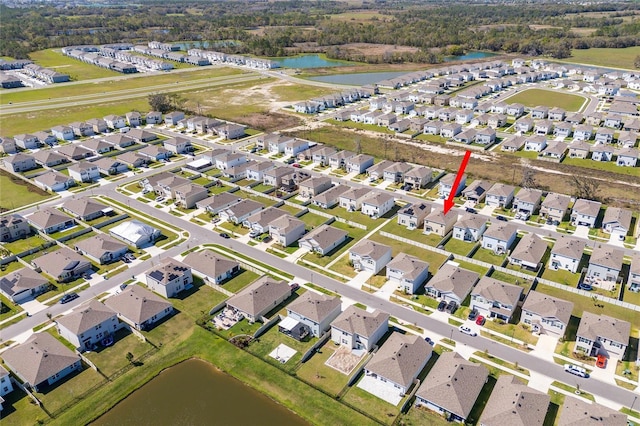 drone / aerial view with a residential view and a water view