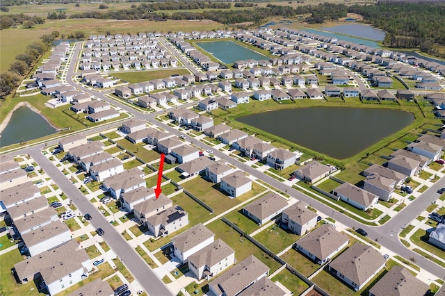 bird's eye view with a residential view and a water view