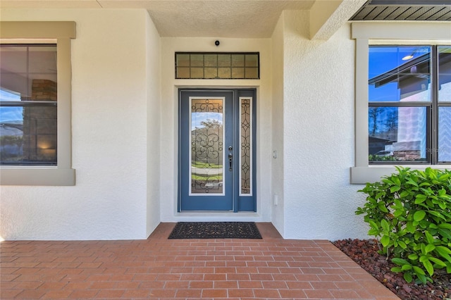 entrance to property with stucco siding