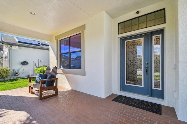 property entrance with stucco siding