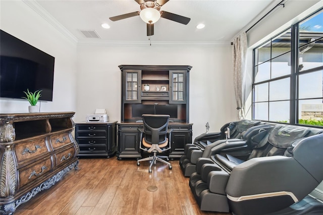 home office featuring visible vents, wood finished floors, ornamental molding, and a ceiling fan