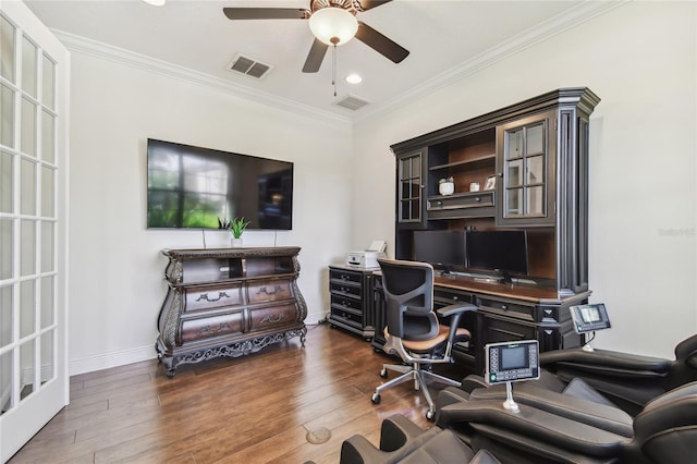 office space with a ceiling fan, crown molding, wood finished floors, and visible vents