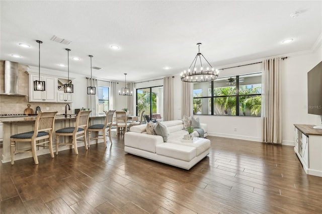 living area with visible vents, baseboards, dark wood-type flooring, and a chandelier