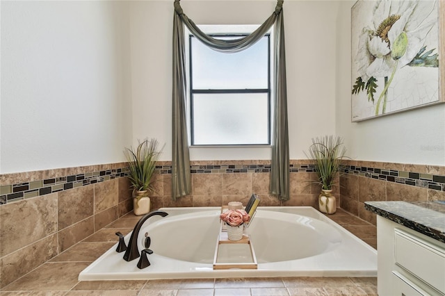 bathroom with vanity and a garden tub